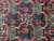Macro view of willow, grapevine and blossom panels woven in navy, brown and cream wool