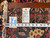 Reverse of rug with dealer tag, measuring tape and leather binding confirming 9'5" x 12'