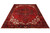 8'2" x 10'5" vintage Heriz rug photographed at an angle with ivory spandrels and black border
