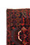 Corner detail showing ivory fringe, navy floral border and hand-knotted wool pile of this Persian rug