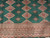 Detail of the ivory multi-band border with running geometric motifs meeting the green diamond lattice field