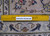Ruler against the pile measures knot density on this 8x12 hand-knotted Persian wool rug