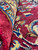 Folded pile close-up showing dense natural wool knots and the deep burgundy color of this rug