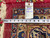 Reverse of the 9'9 x 11'7 Kashan with inventory tag and tape measure showing width