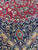 Corner spandrel detail where the rose red field meets the navy main border and ivory guard