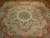 8'10" x 12' Chinese needlepoint rug laid on parquet floor with rose border and pink roses