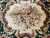 Detail of central ivory medallion bouquet with pink, rose and blue flowers, brown outline
