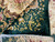 Folded corner revealing dense knotting, ivory cotton fringe and lustrous green bamboo silk pile