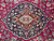 Navy lobed medallion detail on the hand-knotted fine wool pile of this signed Mashad rug