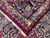Folded corner exposing cotton foundation, ivory fringe and the knot density on the back