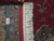 Back of the rug beside a ruler and authentic hand knotted tag showing knot density