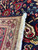 Folded back corner revealing tight cotton foundation, fine knotting and clean ivory fringe of Tabriz rug