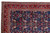 Corner detail showing ivory guard borders, red boteh main border and dense navy floral field