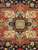 Detail of central rosette panel, sage diamond and angular red leaf motifs in wool