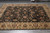 7'7" x 10'2" hand-knotted Indian rug on grey tile showing all-over vine and blossom field
