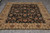 Overhead angle of the 8x10 black and gold wool rug with wide floral main border