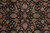 Detail of hand-knotted wool pile showing rosettes, curling leaves and fine brown vine scrolls