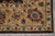 Corner of the 7'7" x 10'2" Indian rug with ivory fringe and layered floral borders