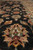 Angled macro shot revealing pile depth, gold lotus blossom and ivory guard border stripe