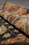 Rolled corner showing natural wool pile thickness, border reverse and clean finished side edge