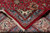 Folded corner revealing the tight hand-knotted back and dense wool pile of this rug