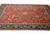 Brick red all-over floral field framed by dark navy palmette border on large Oriental rug