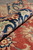 Rolled edge detail revealing medium pile depth, navy border and indigo outlined flower heads