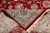 Folded corner revealing tight back weave, roughly 200 knots per square inch, beside red pile