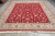 9'1" x 12'2" Pakistani rug displayed on grey tile floor with ivory fringe at front edge