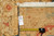 Rug back with tape measure and genuine hand woven Oriental rug tag confirming size
