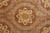 Center field close up with brown rosette wreath, leafy vines and soft blush ground