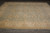 9x12 Ziegler Chobi rug angled on grey plank floor showing ivory border vine scroll
