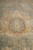 Brick red outlined rosette cartouche motif resting in the soft teal green field wool