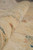 Rolled edge close-up showing hand-spun wool pile texture in soft beige and green tones