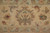 Border palmette close-up with rust, olive and rose leaf motifs on warm camel ground