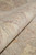 Close-up of soft natural wool pile in ivory, blush and pale green tones