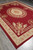 Full length angled shot of the 9 x 12 flat weave rug on grey flooring
