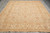 Golden guard borders and rose palmettes frame the ivory field of this Peshawar wool rug