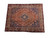 Angled studio view of the vintage Persian Mahal wool rug showing navy spandrels and ivory border