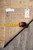 Rug reverse with tape measure, inventory tag marked B 77475 and hand-knotted cotton back