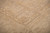 Low angle across the pile emphasizing texture, depth and gentle vegetable dyed camel tones