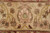 Macro of the ivory border palmette woven in soft green, rose and gold Ghazni wool