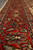 Madder red main border close-up with palmettes, navy rosettes and ivory guard stripe