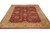 Angled floor view of 9x11 hand-knotted Chobi Peshawar rug showing burgundy field and camel border