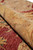 Rolled edge close-up showing supple handle, cotton foundation and lustrous Ghazni wool in gold and red