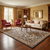 French Country Aubusson rug anchoring a traditional living room with cream sofa and burgundy armchairs