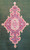 Close-up of the red and sky blue floral medallion set on the deep green open field