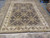 Full length 9x12 Indian wool rug showing balanced all over design and ivory fringe