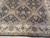 Close view of sage green diamond lattice panels and rosettes set against the black field