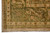 Corner detail of olive green main border with ivory guard band, pink blossoms and curling vines